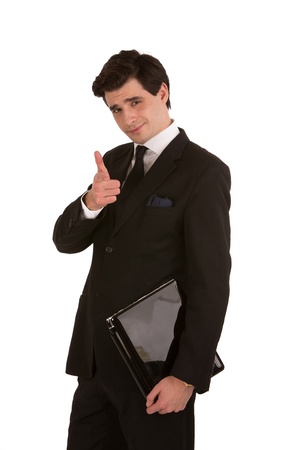 Profile shot of a handsome model posing as a business executive and pointing finger towards the camera の写真素材