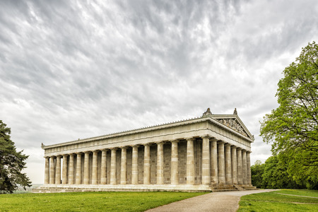 Image of the Walhalla in Bavaria, Germany with green meadow and dark cloudsのeditorial素材