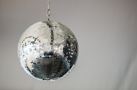 Photo of a Mirrored Disco Ball taken at a concert with a white backdropの写真素材