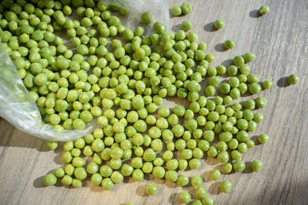 fresh peeled green peas are in a bag on the table. stubs of green peas. peeled fresh green peas.food...