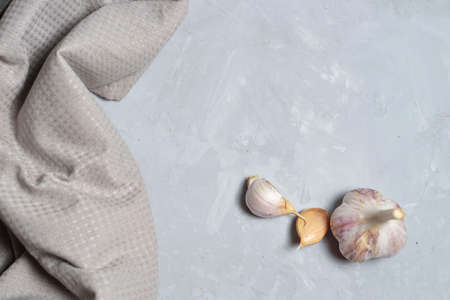 homemade garlic from a vegetable garden on a gray concrete background.の写真素材