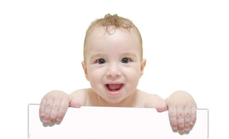 Adorable baby holding a white boardの写真素材