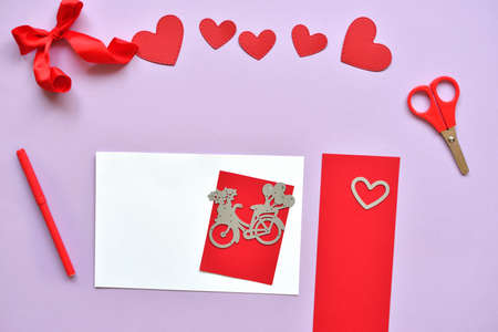 DYI master - class on creating cards for Valentine's Day. scrapbooking with ruler board and cutting red bike and hearts. Craft tools and supplies. Step-by-step instructions. Do it yourself. Step 5.の写真素材