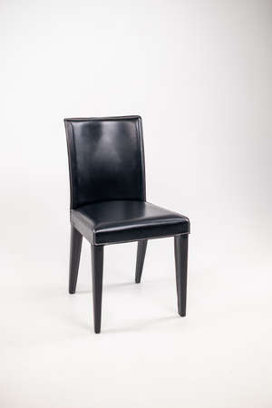 modern leather black chair with a back on a white isolated background. Furniture for home and officeの写真素材