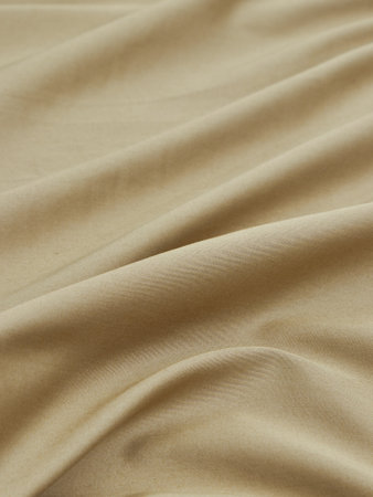 Close-up of beige satin fabric texture for background.の写真素材