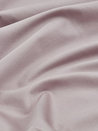 Close up of rippled pink satin fabric as background textureの写真素材