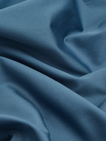 blue satin texture background close up, crumpled fabric clothの写真素材