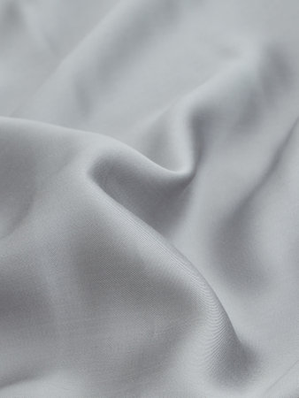 Closeup of rippled gray satin fabric textured backgroundの写真素材