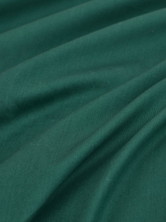 Green satin fabric texture as background. close-up image.の写真素材