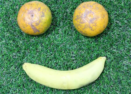 Emotion smiley face made with banana and oranges.の写真素材