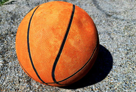 Basketball on the sand for children's games outside hollidays. Equipment  for fitness and funny game with leather leisure object orange and sport symbol team round sphere,の写真素材