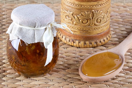 Two jar of honey from flowers on rustic background.の写真素材