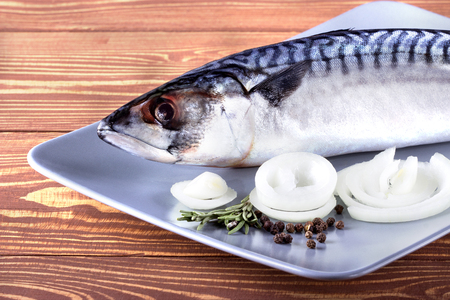 Delicious fresh sea fish on wooden background. Healthy food, diet or cooking conceptの写真素材