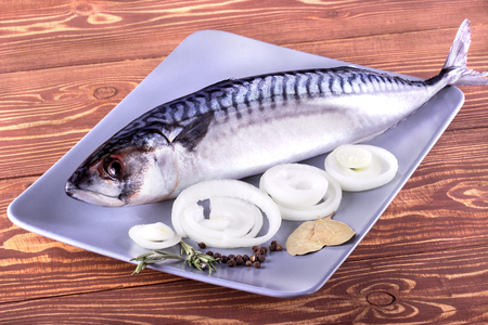 Delicious fresh sea fish on wooden background. Healthy food, diet or cooking conceptの写真素材