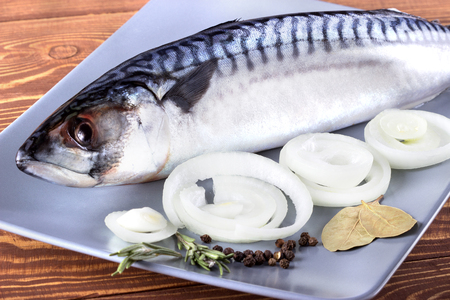 Delicious fresh sea fish on wooden background. Healthy food, diet or cooking conceptの写真素材