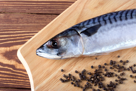 Raw fish with spices on wooden tableの写真素材