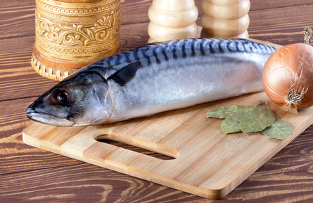 Raw fish with spices on wooden tableの写真素材