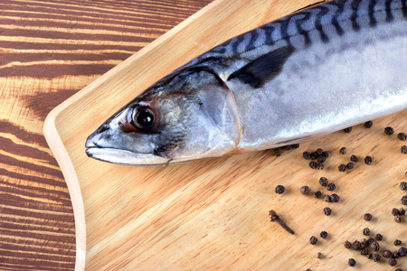 Raw fish with spices on wooden tableの写真素材