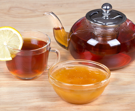 A teapot and a cup of tea,jar of honey.の写真素材