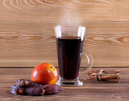 Traditional mulled wine with spices on wooden background. Shallow dof.の写真素材