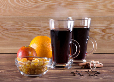 Traditional mulled wine with spices on wooden background. Shallow dof.の写真素材