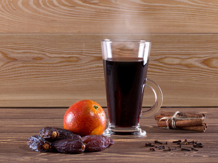 Traditional mulled wine with spices on wooden background. Shallow dof.の写真素材