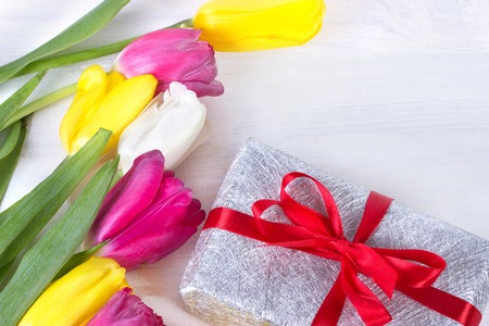 Fresh pink tulip flowers in gift box on wooden table.の写真素材