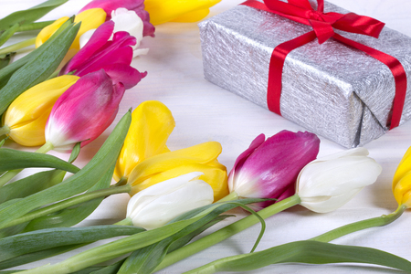 Fresh pink tulip flowers in gift box on wooden table.の写真素材