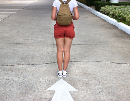 Travel concept.Woman with hat and backpack walkingの写真素材