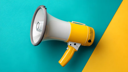 Megaphone on blue and yellow background. 3d illustration.の写真素材