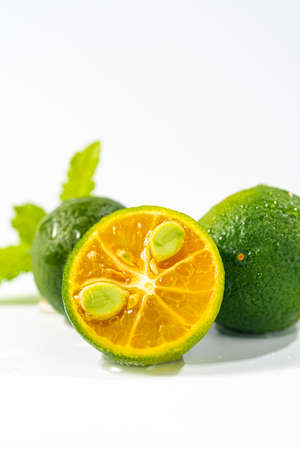 Cut kumquat cross section close-up on white background