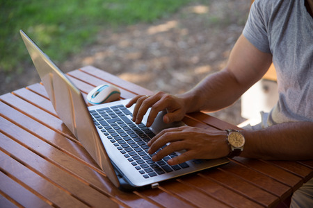 Man working on laptop.Man working while on vacation.Man outdoors with laptop computer working on vacationの写真素材