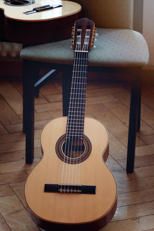 Acoustic guitar on a wooden floor in the interior of the roomの写真素材