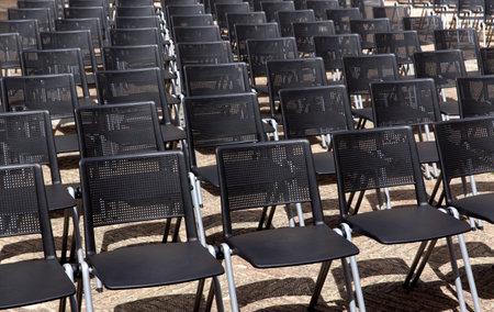 Rows of black chairs in a row in a row at a concertの写真素材