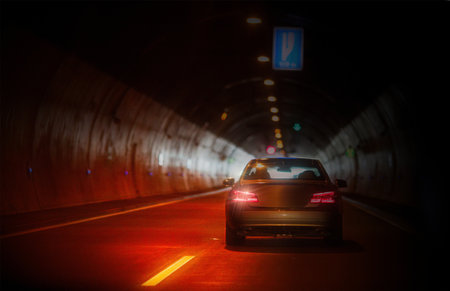 Car on the road in the tunnel. Car driving on the road at night.の写真素材