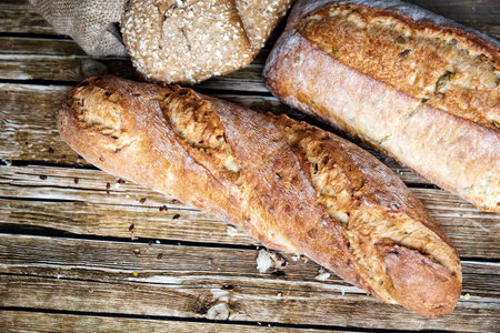 Freshly baked homemade bread on rustic wooden background. Healthy food