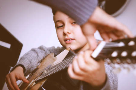 Close up Pensive Boy Leaning his Face on his Handsの写真素材