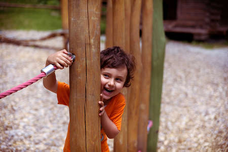Little child playing on background in parkの写真素材