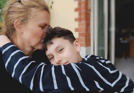 Portrait of lovely mom and happy child enjoying spending funny time together. Mother kissing  Sohnの写真素材