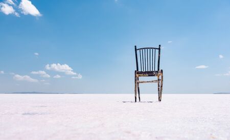 Old rustic empty chair at dry salt lake, Minimalism concept.の写真素材