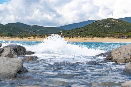 View on waves splashing on rocks from shore. Holiday destination concept. Mediterranean sea.の写真素材