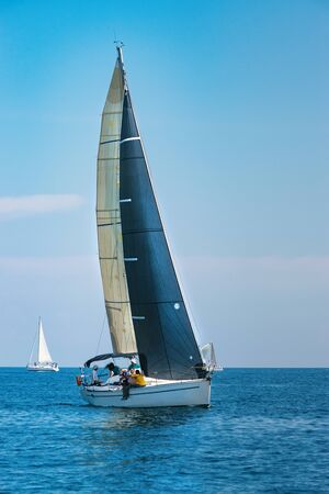 Sailing regatta in blue sea at sunny day. Yachting adventure concept.の写真素材