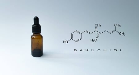Bottle with pipette and chemical formula with text "BAKUCHIOL" on green background. - Bakuchiol retinol alternative concept.の写真素材