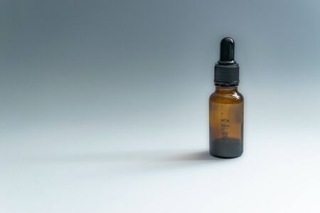 Black skincare bottle with pipette in white background with copy space. - Bakuchiol retinol...