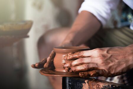 Close up male hands making pottery.の写真素材