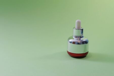 Pipette bottle of bakuchiol extract on green background. Copy space. - Retinol alternative concept.の写真素材