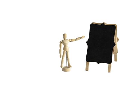 Wooden human model showing on empty blackboard. Isolated, mockup, copy space.の写真素材