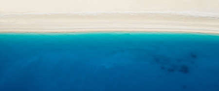 View from above on beautiful coast with white sand and aqua blue water and steep cliffsの写真素材