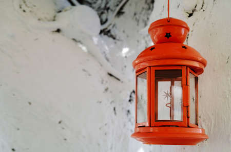 Red old lantern hanging on a tree outdoors at daytime, old antique objects concept.の写真素材