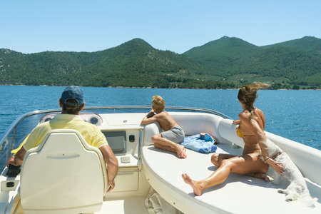Family spending time together on motor yacht.の写真素材